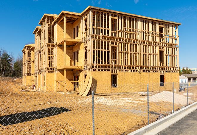 a panoramic view of temporary chain link fences on a job site, separating work zones in Lago Vista, TX